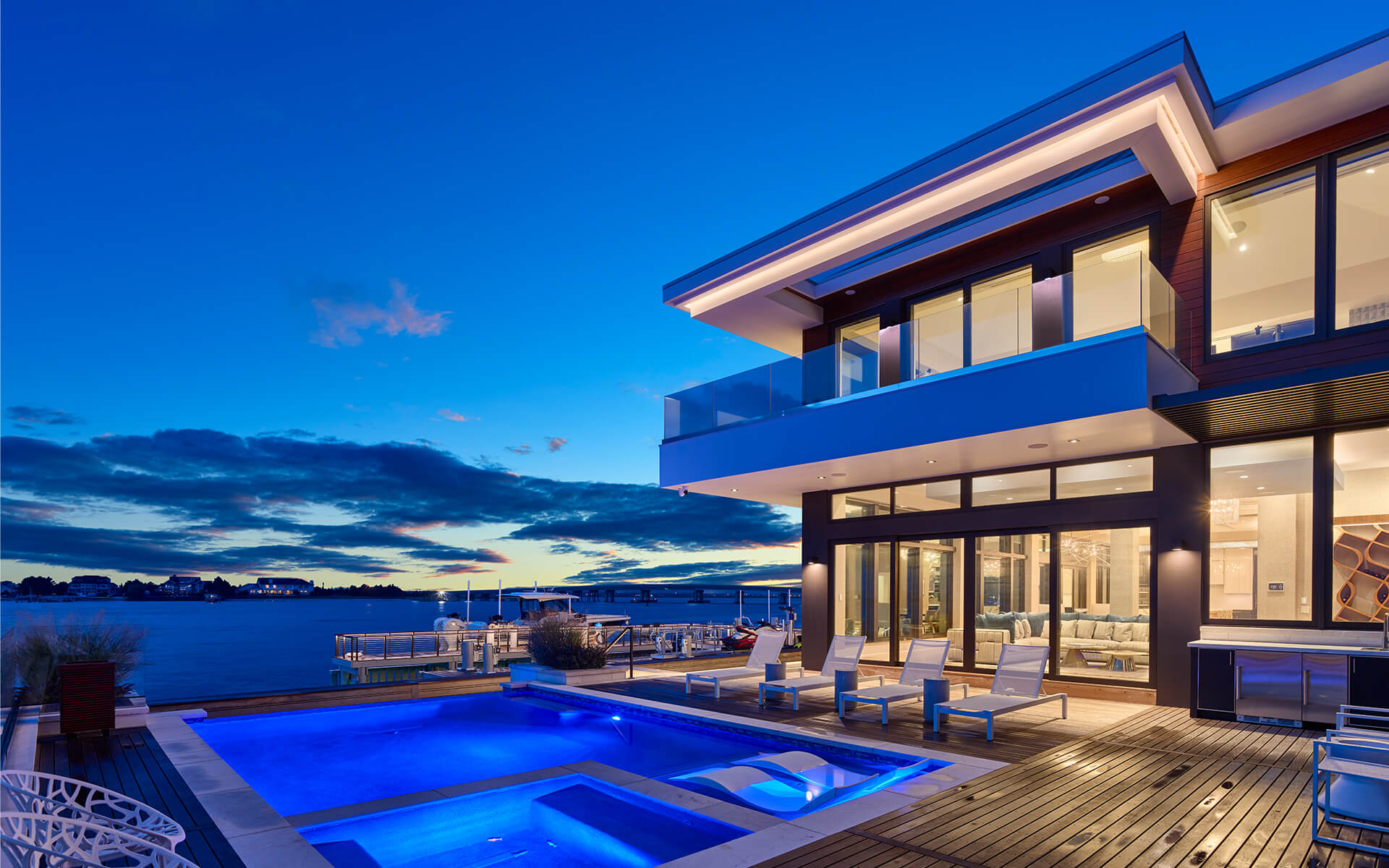 Sunset on the bay featuring integrated lighting, motorized shades, and smart home technology in a Longport residence