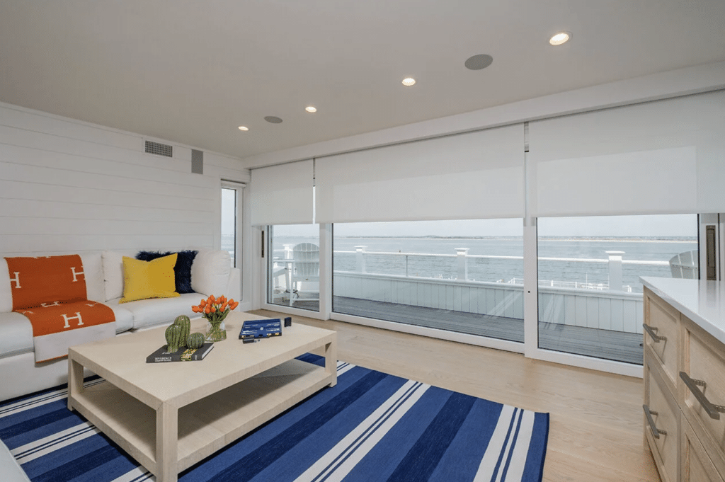 Motorized shades and integrated lighting in a coastal Jersey Shore living room