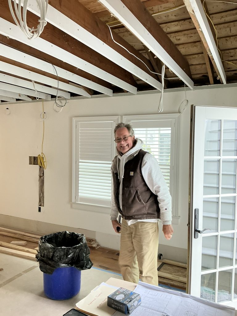 Builder reviewing existing conditions during a Stone Harbor lighting renovation