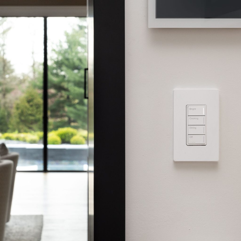 HomeWorks-compatible Lutron Sunnata keypad installed beside a large glass door