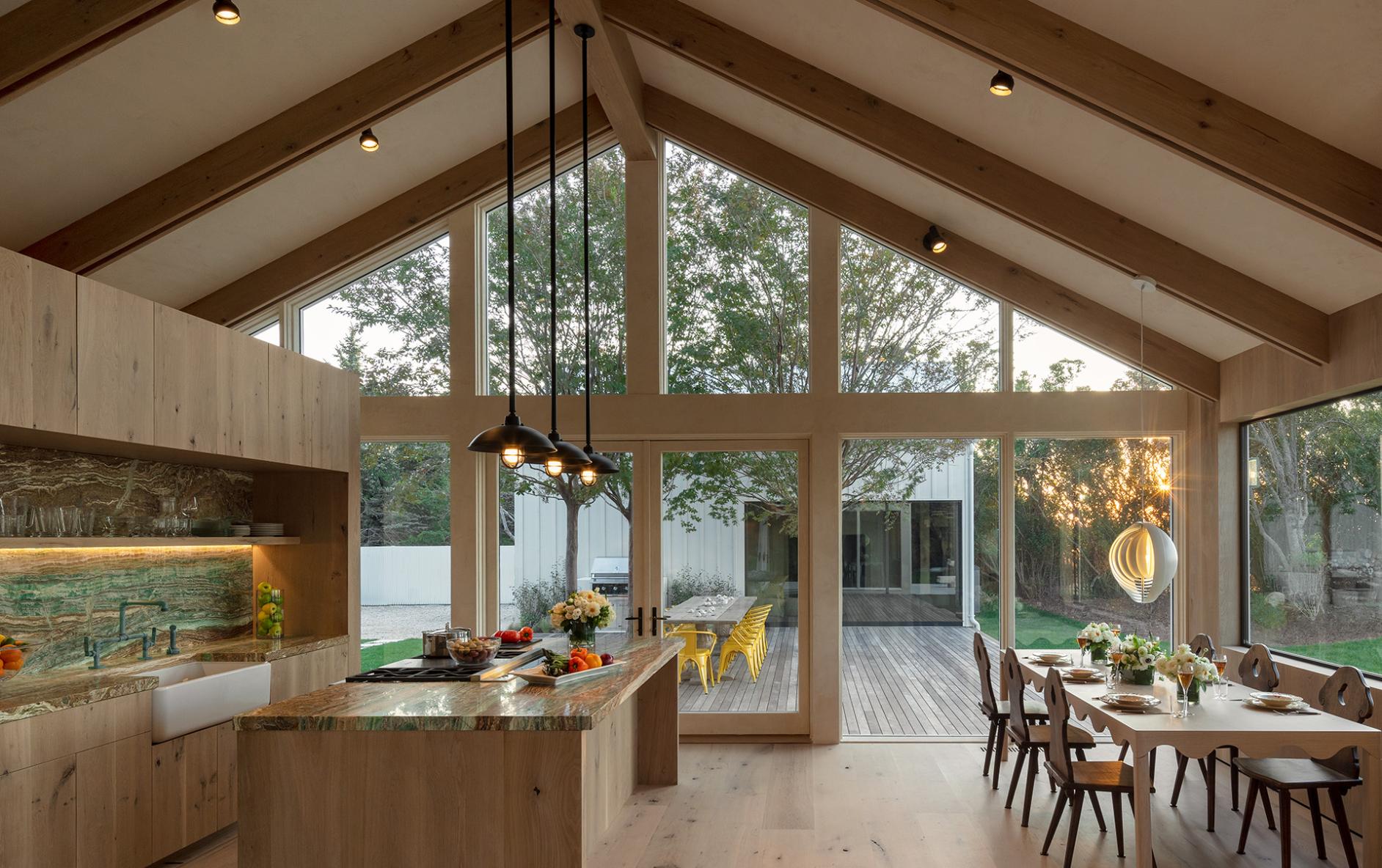 Lutron HomeWorks lighting and motorized shades coordinated in an open kitchen and great room