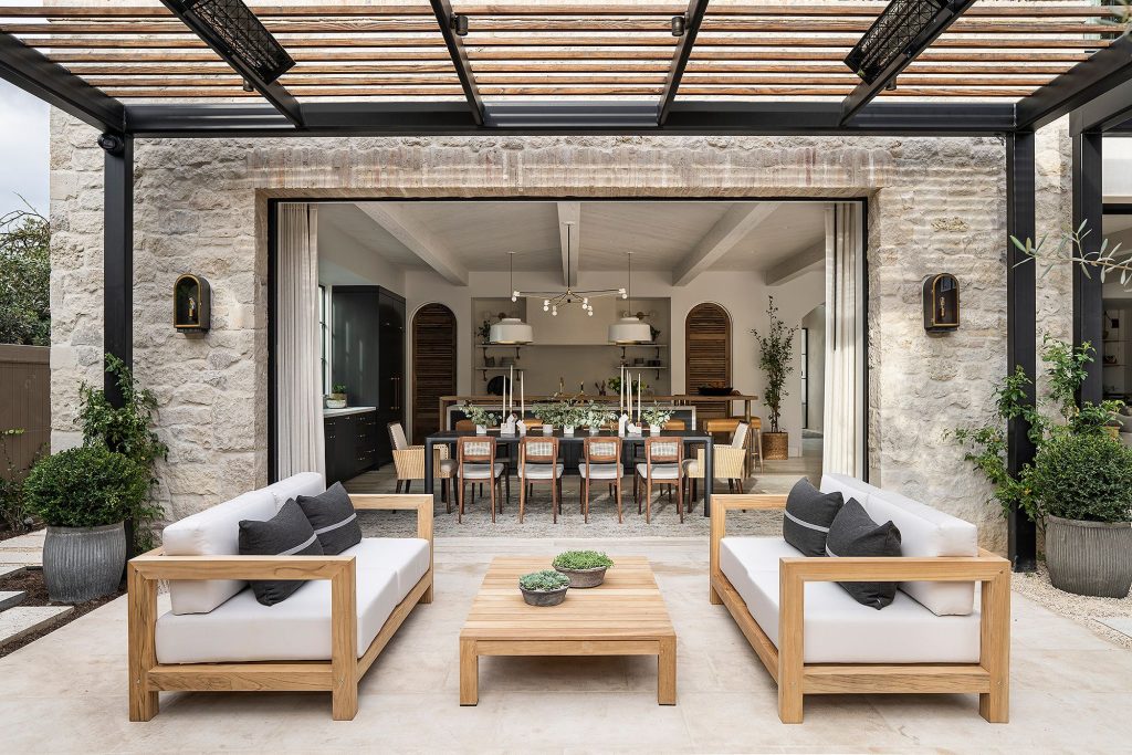 James Wedge X outdoor speakers mounted along a pergola above a patio entertaining area