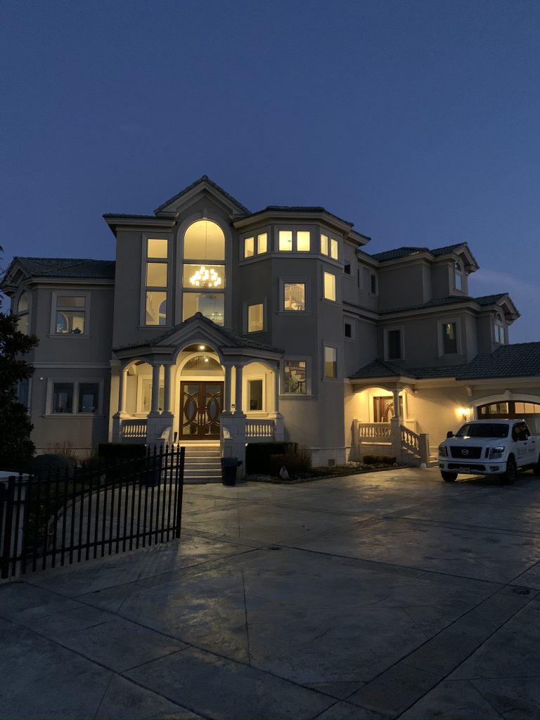 Cape May residence at dusk with integrated lighting and smart home technology